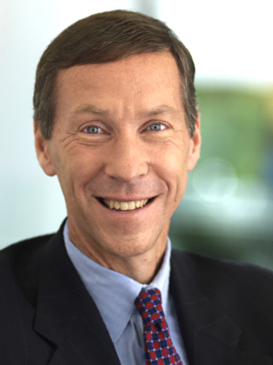 F. William McNabb III is shown smiling, wearing a suit, dress shirt, and tie.