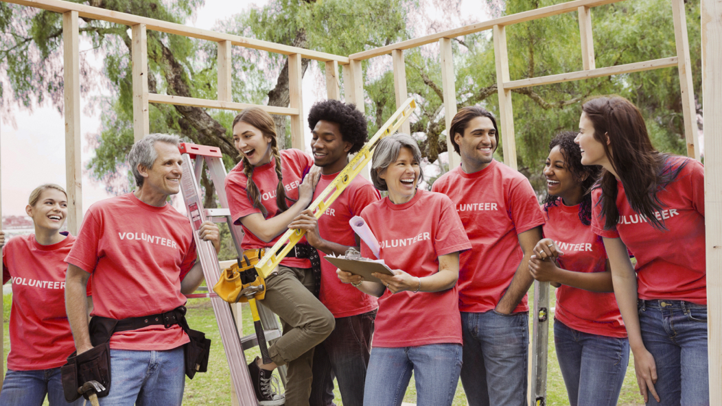 People talking at a volunteer event where they are building a home--an example of the type of volunteer activity that reflects Vanguard’s strong corporate culture and commitment to stewardship.