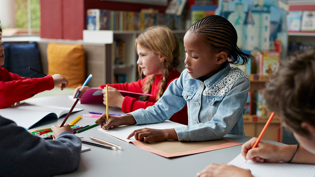 Pre-school age children interacting in a classroom setting. Vanguard supports many children like this through volunteer programs.